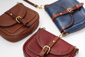 Open image in slideshow, Navy blue leather red leather pebble brown leather saddle bag handmade shoulder bag by designer Kimberly Fletcher
